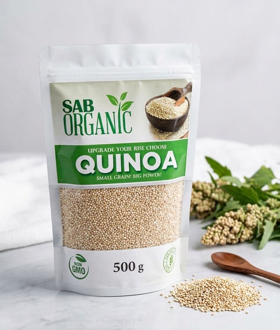 SAB Organic Quinoa 500g resealable pouch with a green label, beside quinoa grains and a wooden spoon.